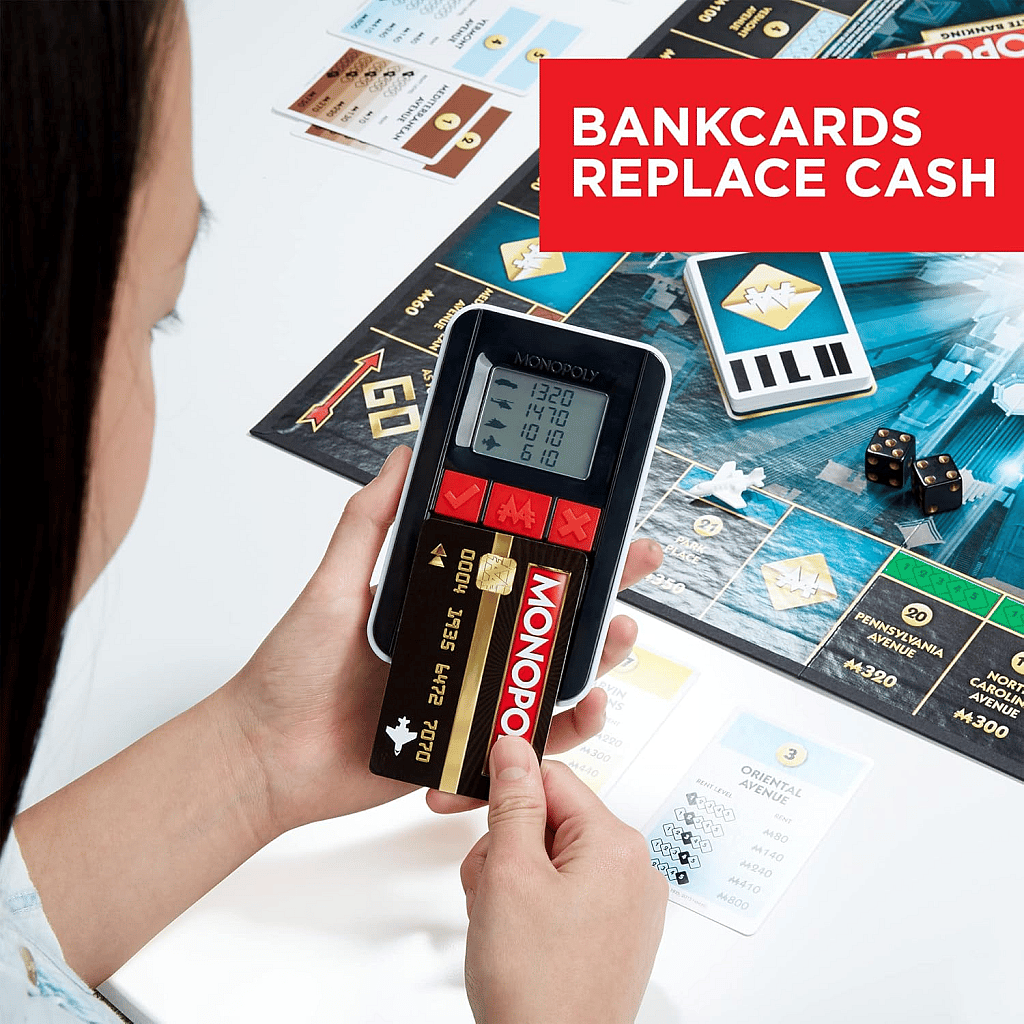 Monopoly Ultimate Banking Edition banking machine and bank card withe game board in the background