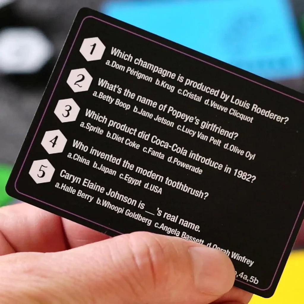 close up of a Hexaquest trivia card showing how to play the classic card game