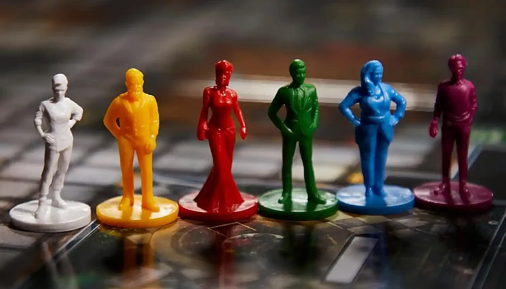 Close up of the six different clue board game murder suspect tokens