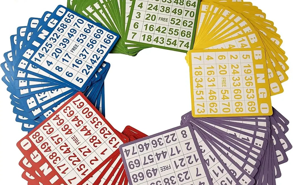 A fanned arrangement of 100 Bingo cards in five colors: blue, green, yellow, purple, and red. The cards are spread out in a circle, with the word "BINGO" visible on each, along with the grid of numbers.