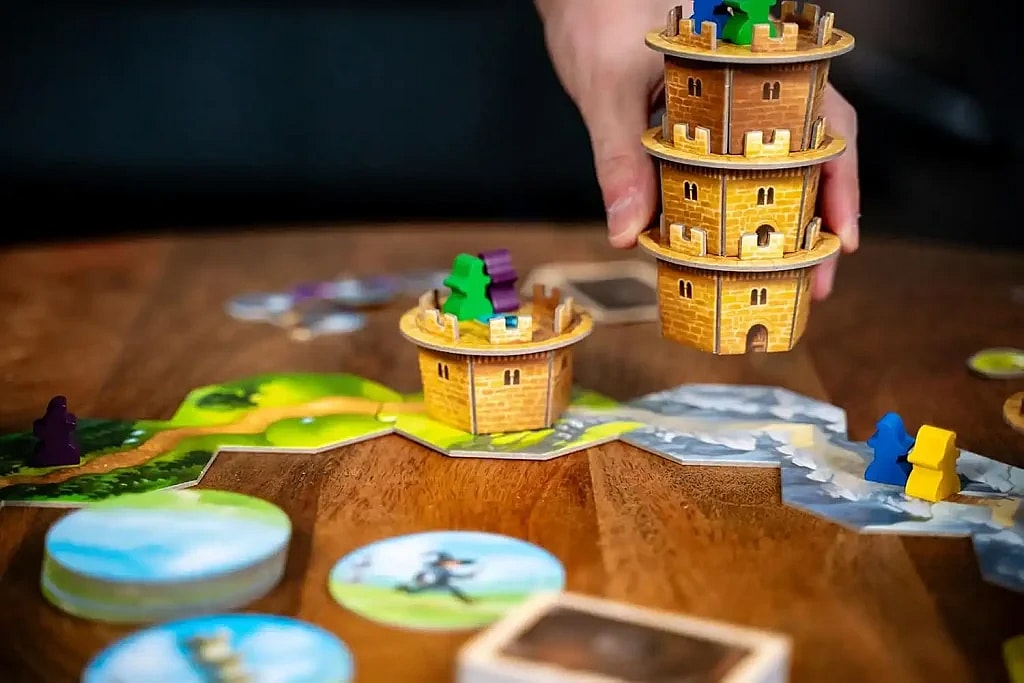close up of moving a tower with wizards on it in the Wandering Towers board game.