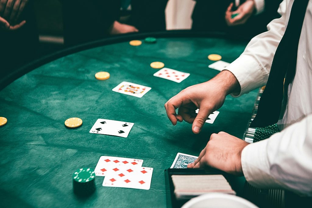 Casino scene with dealer and players, featuring cards and chips, playing Blackjack and creating a suspenseful atmosphere.