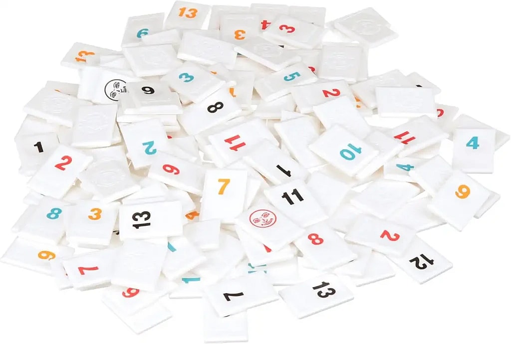 Rummikub tiles all jumbled together in a pile.