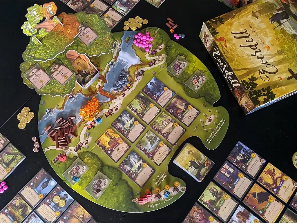 A high-angle, detailed shot of the board game Everdell set up on a black table. The distinctive, beautifully illustrated main game board is visible, shaped like a valley with a large cardboard tree structure (The Ever Tree) at the top left. Various game components are scattered around and on the board, including wooden twigs (resources), small pink, black, and orange berries (resources), gold coin tokens, and numerous square playing cards laid out in the central "Meadow" area. The game box is visible in the upper right corner, and various player tableau cards are spread out in the foreground and along the left side.