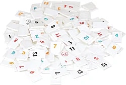 Rummikub tiles all jumbled together in a pile.