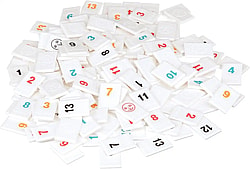 Rummikub tiles all jumbled together in a pile.