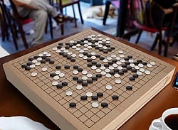 Go game board with black and white pieces on it in a cafe