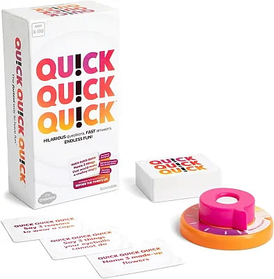 A high-angle photograph displays the box and components for the party game Quick Quick Quick.
The tall, rectangular game box stands on the left. Its design is primarily white with the title "QU!CK QU!CK QU!CK" written in large, bold, orange and pink letters, and the subtitle "HILARIOUS questions. FAST answers. ENDLESS FUN!". It also indicates a player age range of 8-108.
The box's side panel shows the phrase "quick quick quick" with the tagline "The fastest way to have fun".
Scattered in the foreground are several question cards with orange and pink text. Visible prompts include:
"QUICK QUICK QUICK Say 3 reasons to wear a cape".
"QUICK QUICK QUICK Say 3 things your eyeballs cannot do".
"QUICK QUICK QUICK Name 3 made-up flowers".
To the right, a stack of cards rests on a small, white block with the game's logo. Next to that is the unique game timer, which is a bright orange and pink circular device.