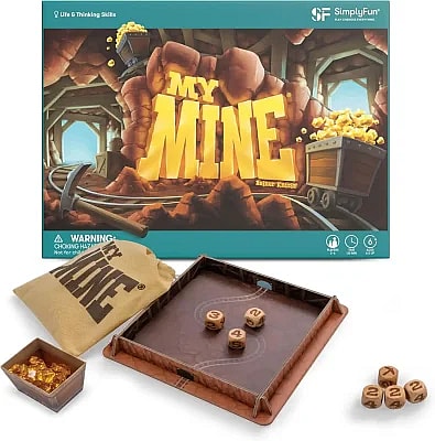 Board game box and components for "My Mine" by Reiner Knizia, featuring a gold mine theme with dice, a drawstring bag, and gold nuggets.