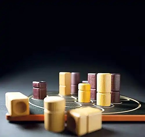 close up of different Quarto game pieces. light and dark colored blocks to play the classic board game of Quarto